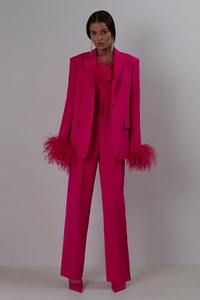 Detail of fuchsia satin suit jacket with ostrich feather cuffs and matching trousers