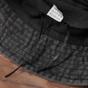 Detail view of the inner 100% cotton lining and adjustable drawstrings of the bucket hat