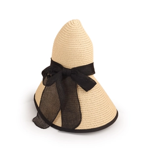 Detail of beige straw sun hat featuring a black mesh bow and ribbon-edged wide brim