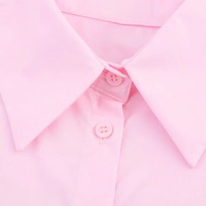Detailed close-up of light pink poplin shirt collar and matching resin buttons