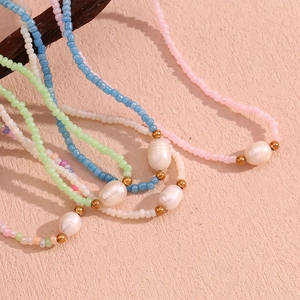 Detail of colorful seed beads and white baroque pearls on bohemian style necklaces