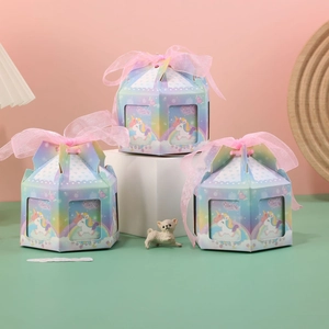 Detail of unicorn themed hexagonal gift boxes with pink ribbons for wedding favors