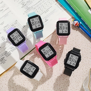 Detailed view of colorful rectangular digital sports watches on an academic study desk
