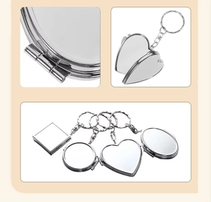 Detailed view of silver metal keychain mirrors in heart, round, and oval geometric shapes