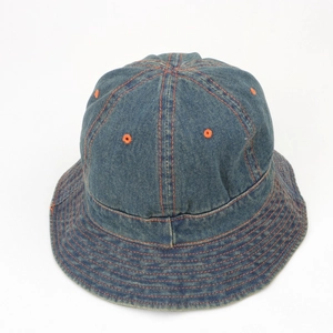 Detailed top view of blue denim bucket hat with orange contrast stitching and eyelets
