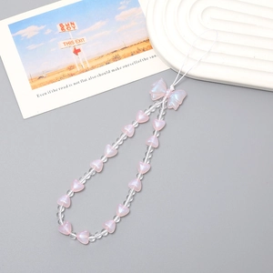 Pink heart bead and bow phone strap with clear beads on a minimalist background