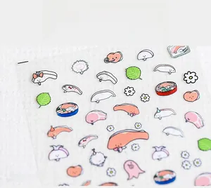 Detailed view of Japanese style nail stickers featuring sushi, salmon and floral patterns