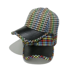 Colorful houndstooth baseball cap with black leather brim and six-panel crown design