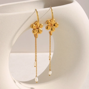 18K gold plated stainless steel flower earrings with pearl tassels on a ceramic stand