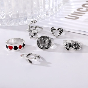 Detail of 6-piece silver vintage punk rings featuring snake, butterfly and rose motifs