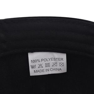 Detail view of the 100% polyester fabric label with washing instructions and origin tag
