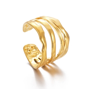 Macro detail of multi-layer irregular golden ring with hammered texture and pearly finish
