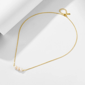 Detail showing the adjustable gold chain with lobster clasp and three round white pearls
