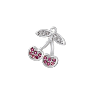 Close-up of a cherry charm with red gemstones and sparkling leaves for DIY jewelry