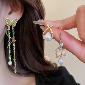 Detailed close-up of zircon flower and pearl stud earrings set for women in gold