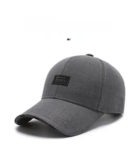 Detail of dark grey baseball cap featuring leather logo patch and printed brim edges