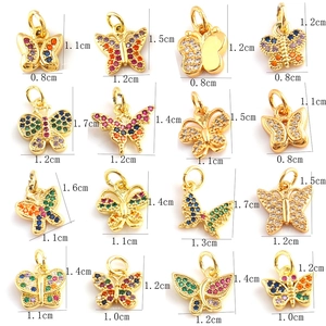 Macro view of butterfly charms with zircon inlays and detailed size measurements