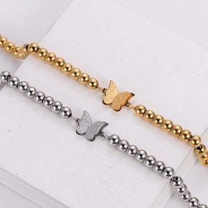 Dual-layer beaded butterfly bracelet in gold and silver finish with matte texture