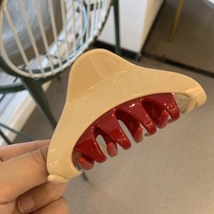 Minimalist beige and red triangular hair claw clip with a glossy finish for women