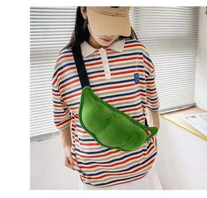 Green plush pea pod crossbody bag shown on a model for size and style reference