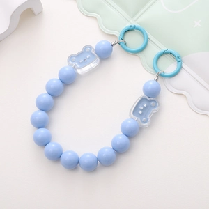 Macro shot of light blue acrylic beaded phone chain with transparent bear charms