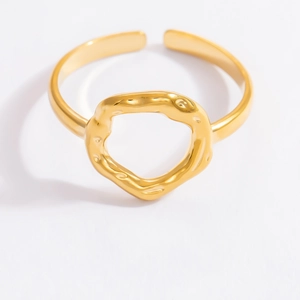 Minimalist gold stainless steel ring with irregular hollow circular design on white background
