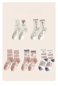 Detailed flat lay of five floral cotton socks in soft pink, white, and purple pastel colors