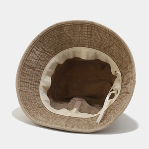 Brown corduroy bucket hat featuring adjustable inner drawstring and fine brim stitching