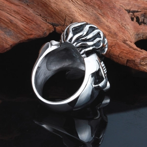 Punk silver skeleton wrench ring for men in gothic rock style on a dark wood background