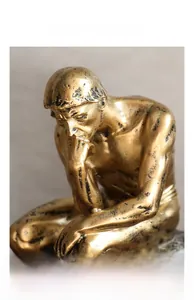 Detailed macro view of the thinker sculpture showing vintage gold texture and cracks