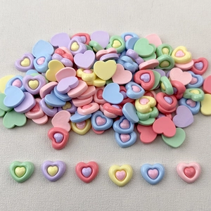 Macro shot of colorful glossy resin hearts for DIY crafts and phone case decoration