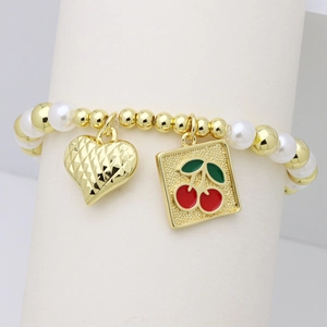 Detail of beaded bracelet with gold metal beads, white pearls, and red cherry charm