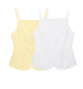 Detail of light yellow and white camisole sets with thin straps and buttoned front
