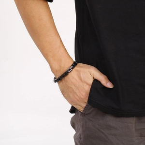 Close-up of black matte stainless steel rectangular link chain bracelet on male wrist