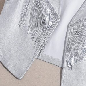 Close-up of silver sequin fringe detailing and metallic finish on the PU leather vest