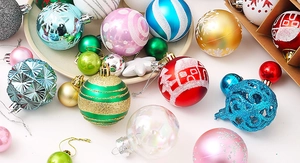 Detailed overhead view of assorted matte and glitter Christmas balls with festive patterns