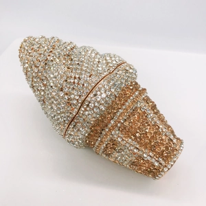 Close-up of shell-shaped evening clutch with champagne and silver rhinestones