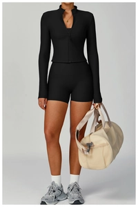 Detail of ribbed knit yoga set with slim-fit high-neck zip jacket and athletic shorts
