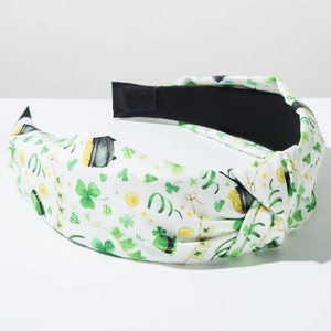 Close-up of St. Patrick's Day knotted headband with green shamrock and coin patterns