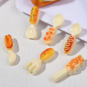 Detailed view of miniature plastic spoons and forks with creative bakery style handles