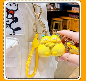 Detailed macro view of yellow silicone pear-shaped keychains with golden metal ring