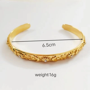Detail of 18K gold plated stainless steel bangle with celestial engraving and size info
