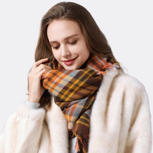 Classic plaid checkered scarf with tassels in brown and orange on a female model