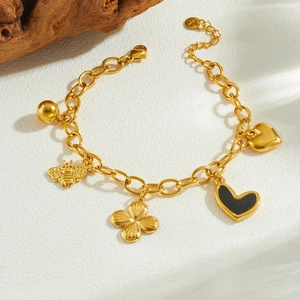 Gold plated stainless steel bracelet featuring bee heart and clover charms on O-chain