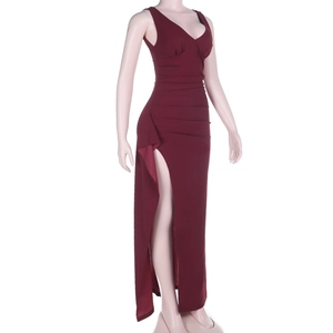 Detail view of burgundy V-neck maxi dress with waist pleats and a side high slit design