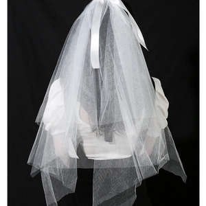 Luminous white tulle wedding veil with LED lights and ribbon bow on black background