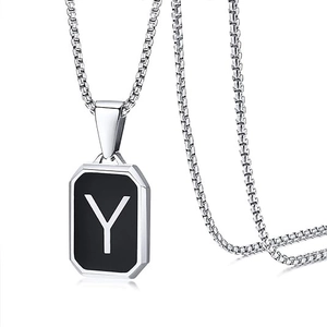 Close-up of black square pendant with white letter Y and silver box chain detail