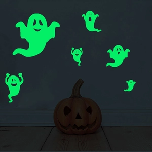 Glow in the dark ghost wall stickers for Halloween decoration in a dark room setting
