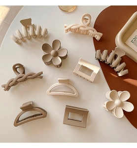 Detailed overhead view of assorted minimalist Korean hair claws in earth-tone colors