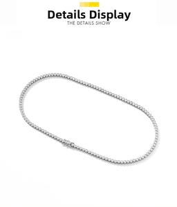 Detailed macro view of silver tennis necklace featuring 2mm moissanite round cut stones